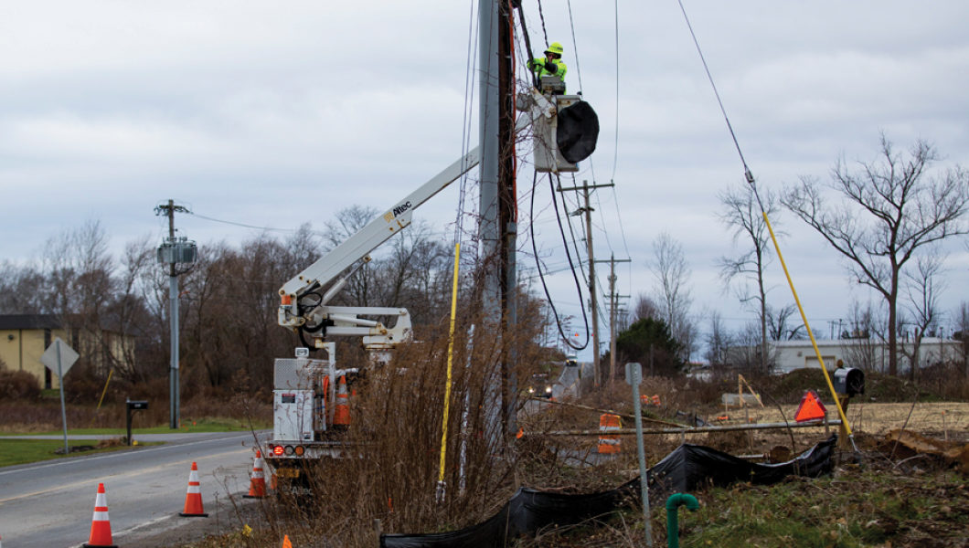 Spectrum Technician repairing network lining